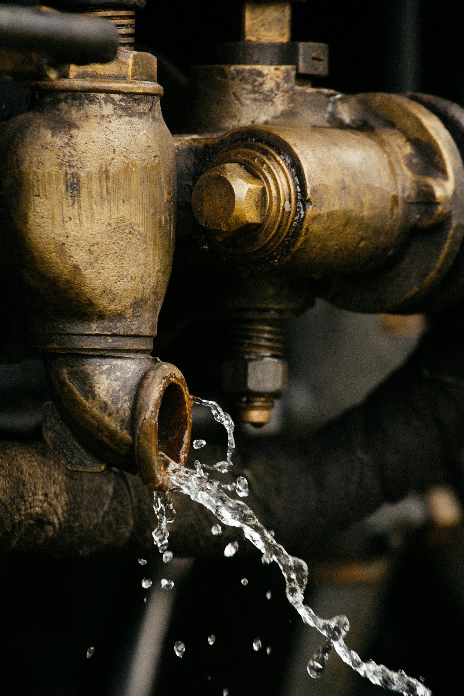 Water dripping from a worn brass pipe fitting