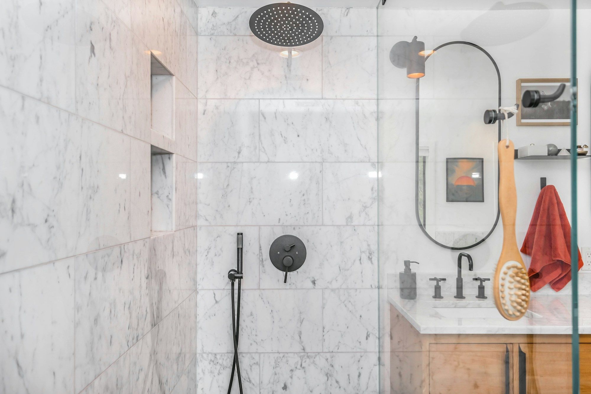 Marble shower with a rain head and a black hand shower