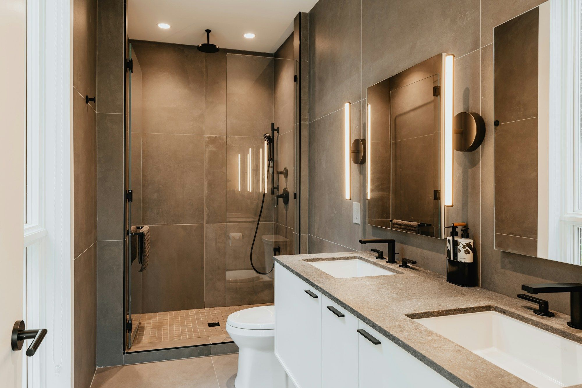 Tiled shower room with a glass door and a stone vanity